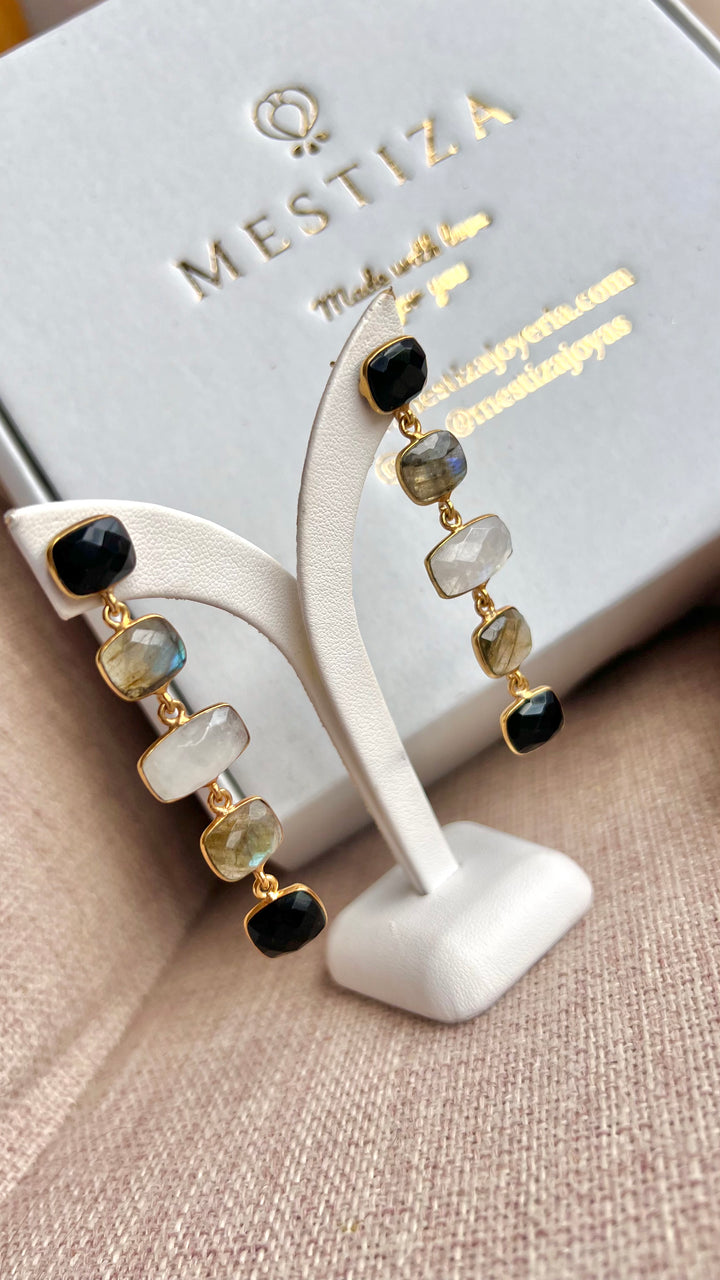 Earrings with black Tui stones