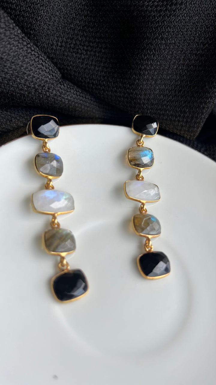 Earrings with black Tui stones